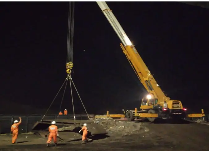 One of our night activities: Our team operates a crane to move heavy equipment.