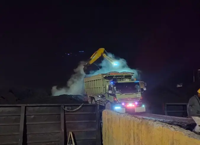 One of our night activities: A truck discharges coal into our barge. 