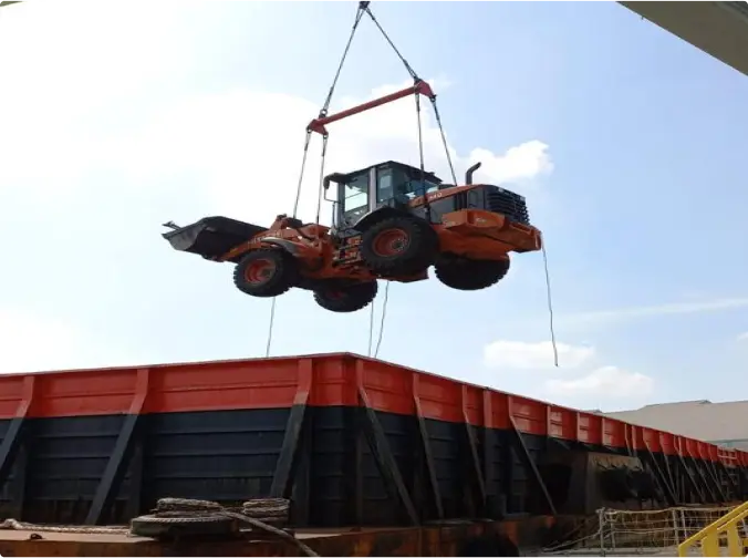 Heavy equipment is being moved into one of our barge ships.